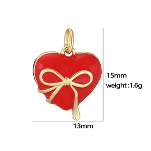 Red heart pendant with golden bow ornament 15mm x 13mm professional studio view