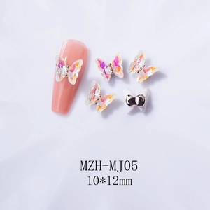 Detailed macro view of 3D aurora crystal butterfly nail charms with 10x12mm dimensions