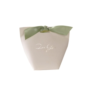 Elegant trapezoid wedding gift box in soft pink with green ribbon and gold foil text