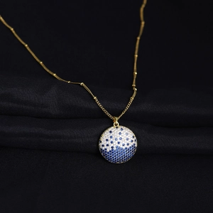 Elegant planet pendant necklace with gold chain and blue white crystals on black silk