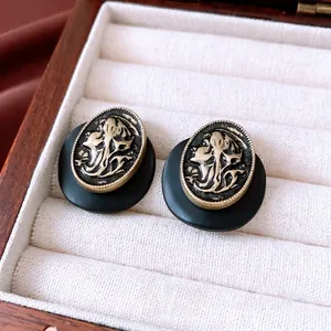 French vintage oval portrait earrings in gold finish with matte black resin detail