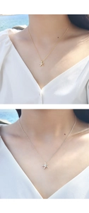 Starfish pendant necklace shown in gold and silver finishes on a model neck