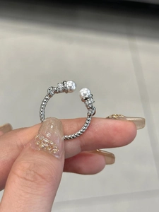 Detail of S925 silver twisted rope ring with white pearls and sparkling crystals