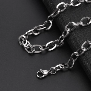 Detailed close-up of a silver stainless steel coffee bean link chain with lobster clasp