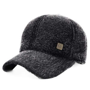 Thick winter faux fur baseball cap in dark grey with golden metal badge detail