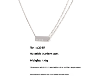 Detail of silver rectangular pendant with engraved text and chain length measurements