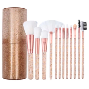 12-piece makeup brush set with gold glitter handles and matching storage tube