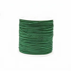Detail of 0.8mm dark green jade cord on white plastic spool for jewelry weaving