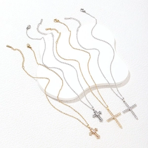 Cross pendant necklaces in gold and silver steel featuring pave-set cubic zirconia crystals