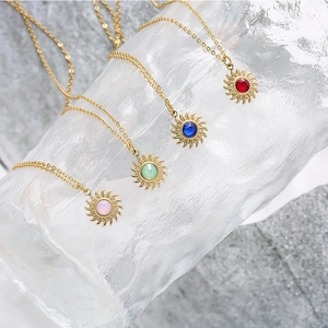 Golden sunburst pendant necklaces with colorful round gemstones in four vibrant shades