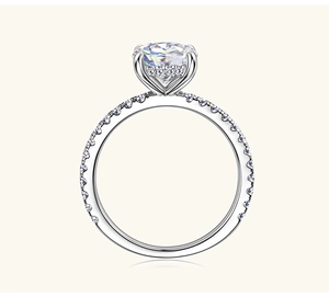 Macro view of 2ct round moissanite ring with hidden halo and pavé band in silver