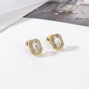 Macro shot of 18k gold plated earrings featuring rectangular zircon center and pave halo