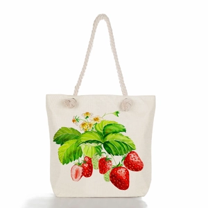 Macro detail of canvas shoulder bag with vibrant strawberry print and hemp rope handles