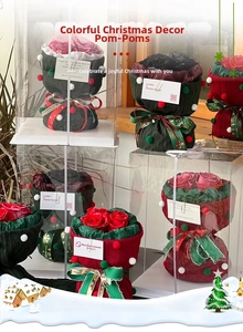 Close-up of Christmas bouquet with knitted roses and colorful plush balls decoration