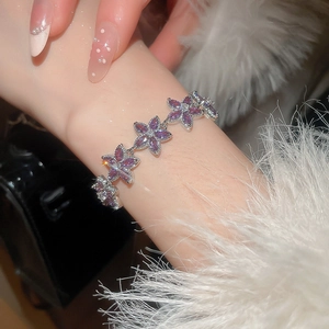 Close-up of elegant purple zircon flower bracelet with sparkling starburst light effects