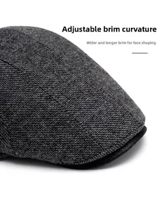 Macro detail of foldable wide brim grey wool beret showing premium tweed texture