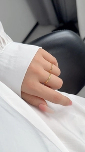 Detail shot of two minimalist gold stacking rings on model for an elegant daily look