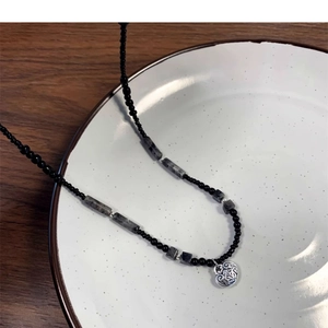 Beaded necklace with bamboo-style accents and a silver pendant in New Chinese style