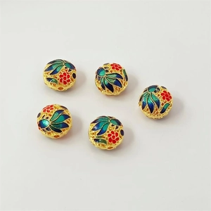 Macro shot of 5 cloisonné enamel watermelon spacer beads with colorful floral patterns