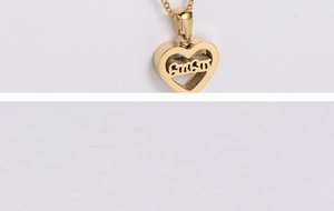 Detail of custom heart-shaped pendant with SUSA nameplate in polished gold finish