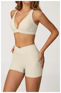 Detailed side view of high-waist yoga shorts with V-shaped waistband and side pockets