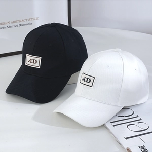 Detail view of cotton canvas baseball caps with AD woven patch in black and white colors