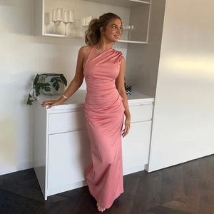 Detail of pink satin one-shoulder maxi dress with elegant ruching and side slit