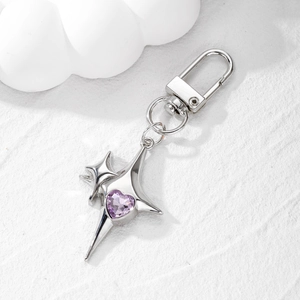Silver star keychain with purple heart gemstone pendant on a clean white background