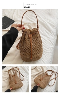 Detail of khaki paper straw bucket bag featuring hollow weave and brown leather drawstring