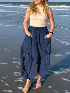 Macro detail of high-waist navy blue linen pants with elastic waist and large side pockets