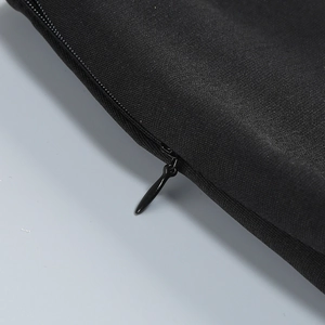 Detailed close-up of a seamless invisible zipper on a black fabric stylish garment skirt