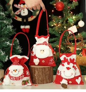 Detail of knitted Christmas gift bags with snowman, Santa, and elk 3D doll designs