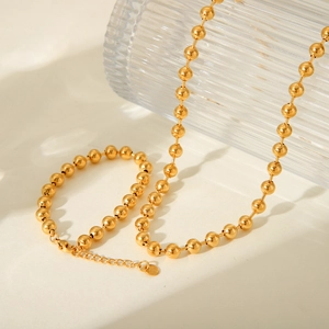 Detail view of a 18K gold-plated stainless steel bead chain with a lobster clasp