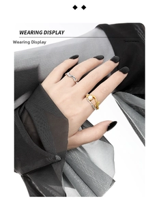 Detail of two-tone irregular hollow silver ring set with freshwater pearl on model finger
