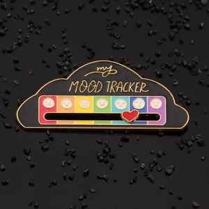 Detail of black cloud mood tracker pin with rainbow slider and red heart indicator