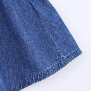 Close-up of denim texture with high-density fabric weave and detailed double stitching