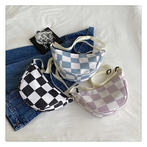 Detailed view of checkerboard crossbody bags in black, blue, and purple color options