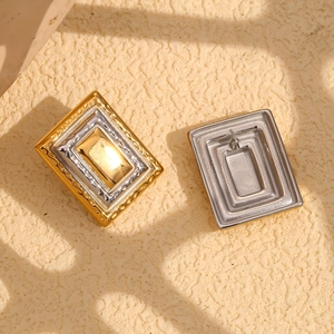Close-up of 18K gold plated rectangular earrings with two-tone embossed texture