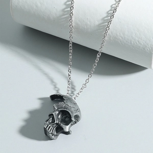 Close-up of gothic silver skull pendant with detailed vintage texture on link chain