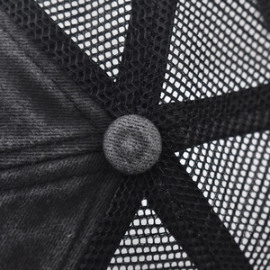 Close-up of baseball cap top showing black mesh fabric and grey fabric button detail