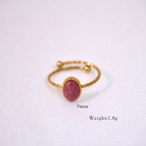 Macro detail of a 9mm pink faceted stone on a gold beaded stainless steel ring