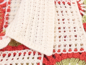 Close-up of handmade crochet hollow texture with floral knit pattern and vibrant contrast colors