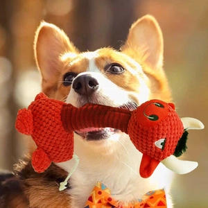 Durable squeaky bull plush dog toy for aggressive chewers shown with a Corgi dog