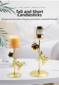 Detail of elegant gold iron candle holder featuring butterfly and rose flower accents