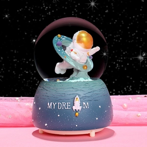 Astronaut crystal ball music box with colorful lights and snow, featuring My Dream base