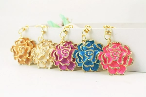 Detailed view of five colorful enamel flower keychains with sparkling rhinestones in a row