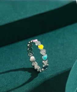 Detail of S925 silver heart ring with colorful enamel and sparkling white stones