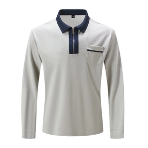 Detail view of men's polo shirt showing the quarter-zip collar and navy contrast trim