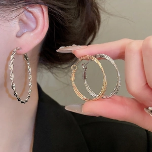 Minimalist geometric twisted hoop earrings in gold and silver finish for women