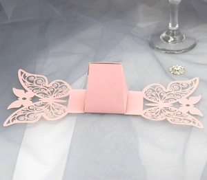 Detail of pink laser-cut butterfly candy box with intricate floral wing patterns